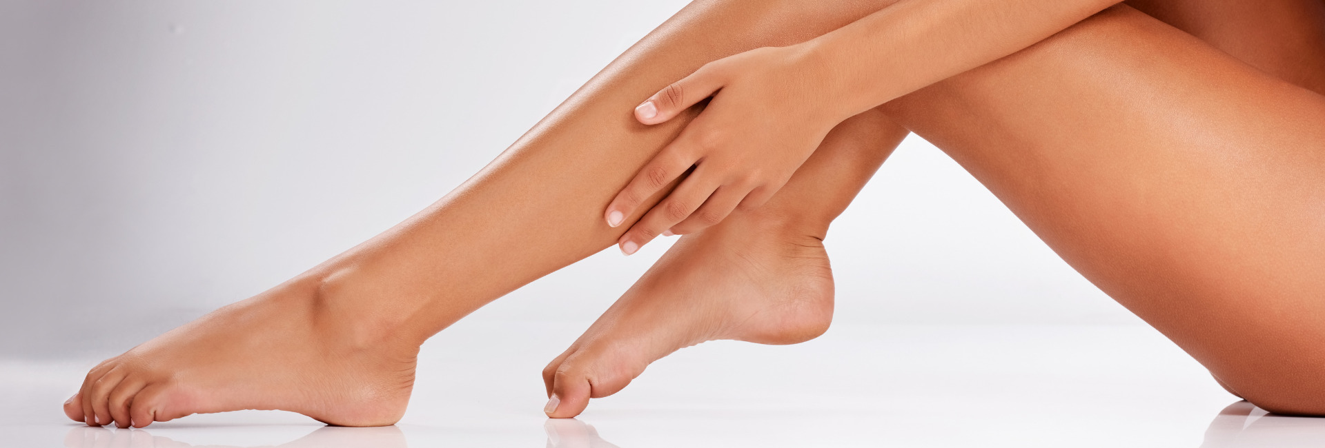 Close-up of a person's legs with a neutral background